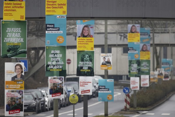 Numerous election posters for the 2026 local elections are hanging one behind the other on several
