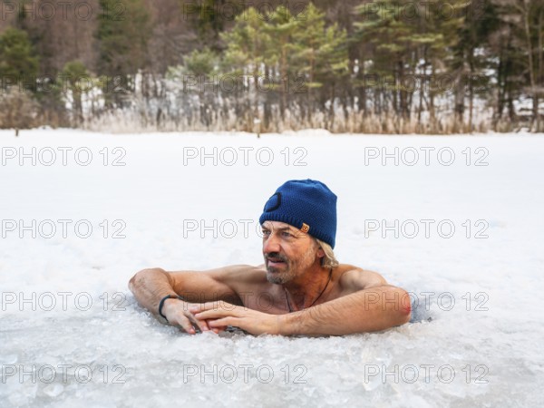 Man with cap, 55, ice bathing in an ice hole, Thumsee, Bad Reichenhall, Berchtesgadener Land, Upper