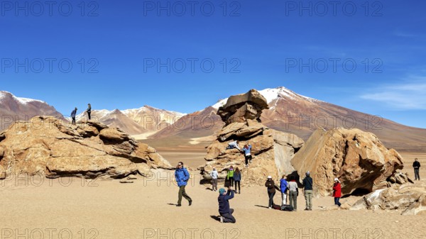 People climb rocks against a majestic mountain backdrop in the desert, The landscape of the