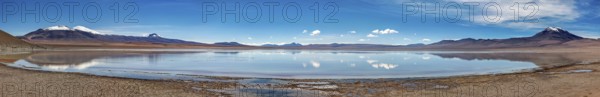 Infinite horizon with a reflecting lake and majestic mountains under a blue sky, Laguna Colorada in