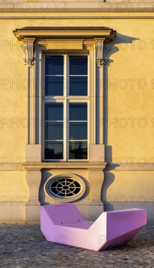 Pink and red plastic furniture for sitting and lying in front of the Humboldt Forum, Berlin,