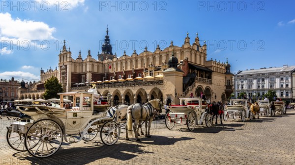 Carriage in front of Rynek with Cloth Hall, from 13th century, Main Market Square, landmark of the