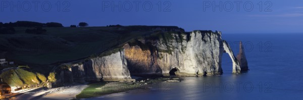 Cliff with the Falaise d'Aval rock gate and the Aiguille d'Etretat rock pin at night, Etretat,