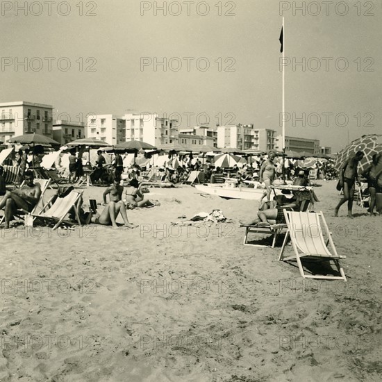 Historical photo summer 1961, tourists, beach, Rimini, Italy