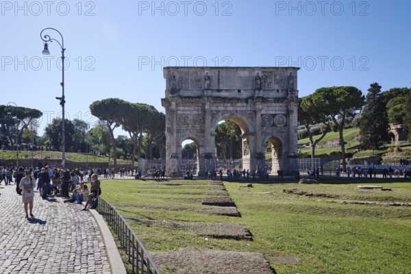 Arch of Constantine with tourists on sunny day, Lazio, Italy