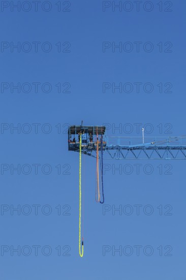 Montreal Bungee Tower installation with dangling long yellow elastic bungee jumping cord, Old Port