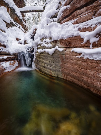 Taugl or Tauglbach flows through the snow-covered and icy red gorge, also Marmorklamm, Bad Vigaun,