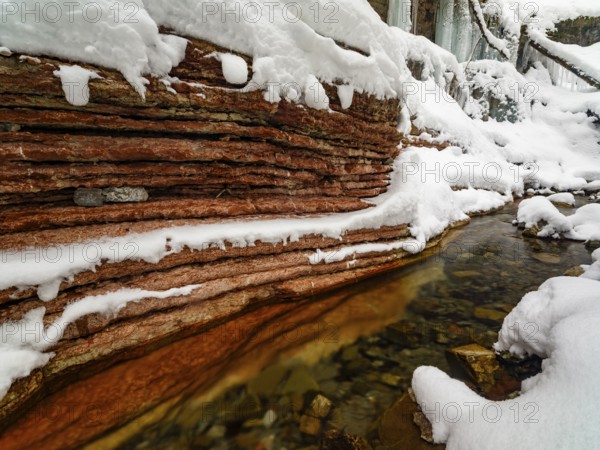 Taugl or Tauglbach flows through the snow-covered and icy red gorge, also Marmorklamm, Bad Vigaun,