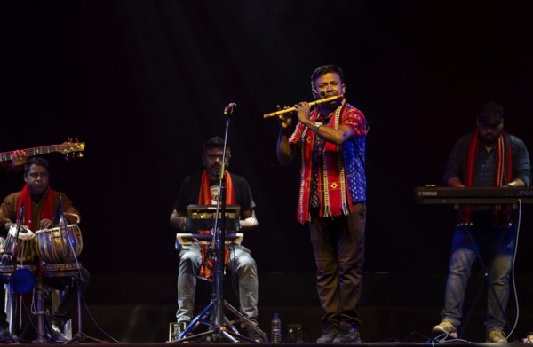Flutist Dilip Hira performs during a cultural evening program at Shilpgram Mohotsav 2026 in