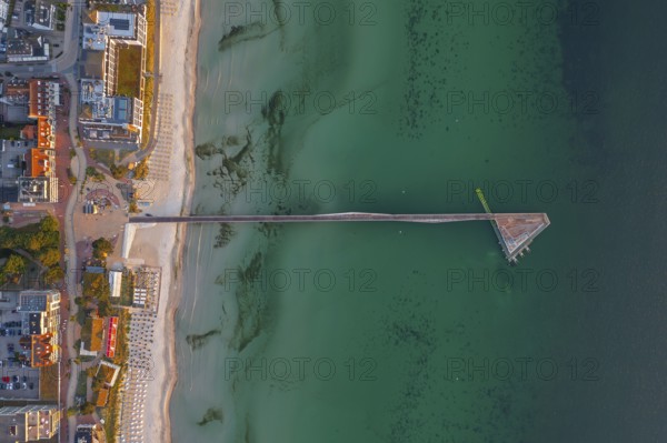 Aerial view over Seebrücke, pier and sandy beach at seaside resort Scharbeutz along the Baltic Sea,