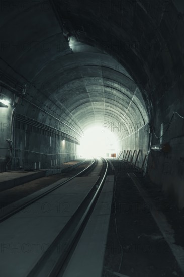 View through a dark tunnel with light at the end. Atmospheric and deserted, acceptance of the