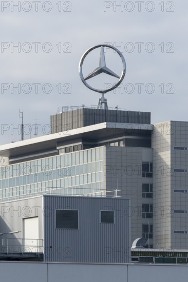 Industrial building with Mercedes-Benz logo on the roof under cloudy sky, Mercedes Star,