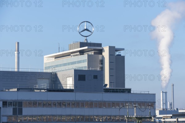 Large industrial building with Mercedes logo, smoking chimney, under blue sky, Mercedes Star,