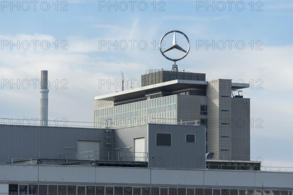 Tall, modern factory building with Mercedes logo in cloudy sky, Mercedes Star,