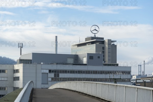 Building with Mercedes logo and front view of a bridge under cloudy sky, Mercedes Star,