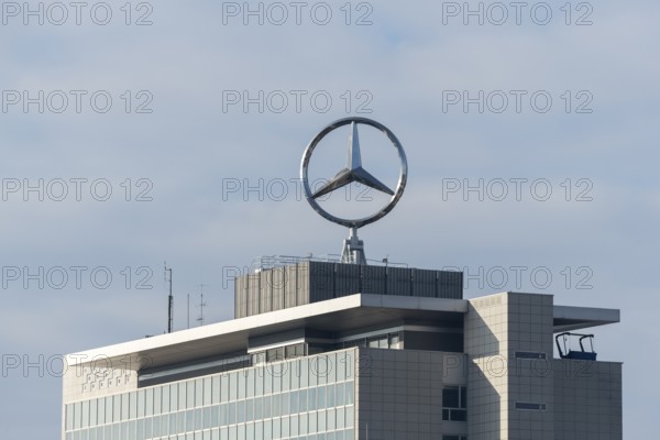 Mercedes-Benz logo over modernly designed building and cloudy sky, Mercedes Star,