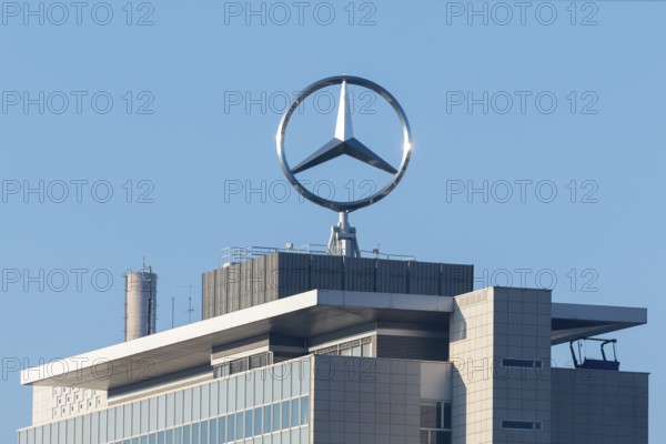 Close-up of a roof with emblazoned Mercedes logo and chimney surrounded by blue sky, Mercedes star,