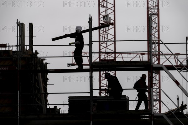 Construction site, scaffolding work on a large construction project, apartments and commercial