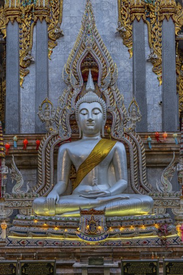 Richly decorated Buddha statue at Wat Suthiwararam Buddhist temple, Bangkok, Thailand's metropolis,