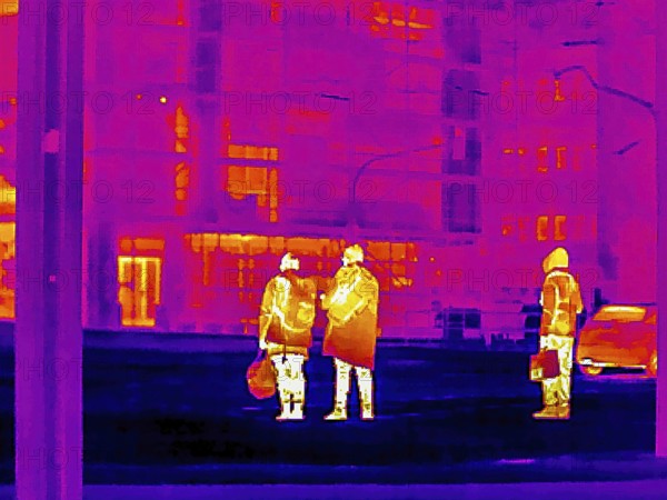 Thermal image or thermography, symbolic photo, interpolated. People traveling in urban areas.