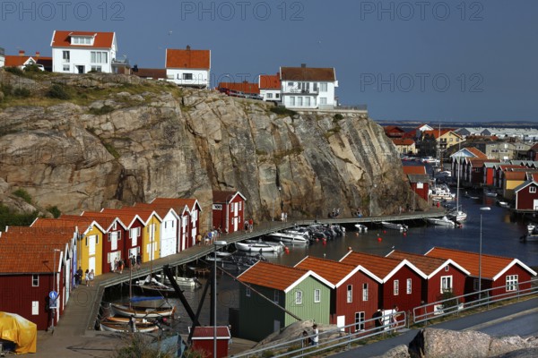 Colourful boathouses along the rocky coast with sea views, Smögen, Västra Götaland, Sweden
