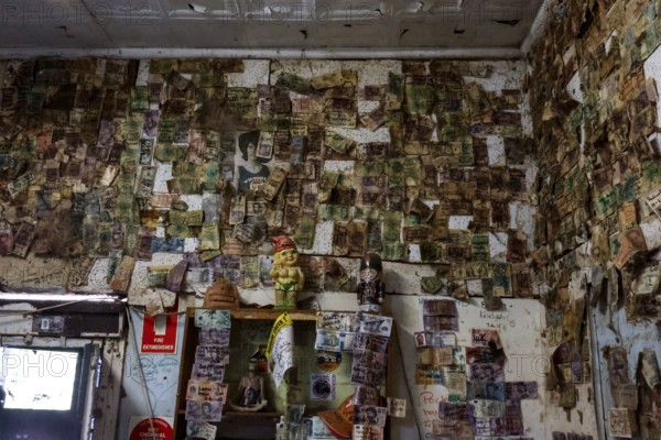 Historic interior of a hotel along the Stuart Highway, covered with notes and reminders, zero