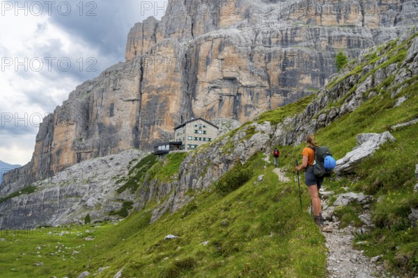 Female mountaineer on a hiking trail in front of Rifugio Maria E Alberto Ai Brentai, mountainous