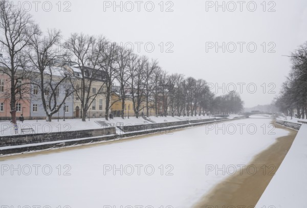 Historic buildings on the frozen Aurajoki river, wintery Turku or Swedish Åbo, Varsinais-Suomi,