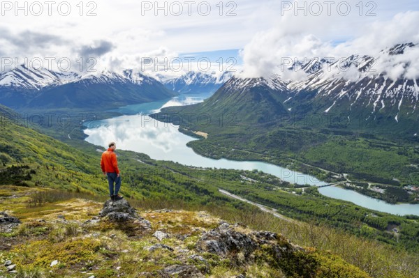 Climber enjoying the view, Slaughter Ridge Trail, view of snowy mountains and turquoise blue Kenai