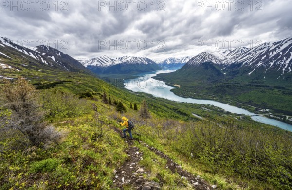 Climbers on a hiking trail, Slaughter Ridge Trail, view of snowy mountains in spring and turquoise