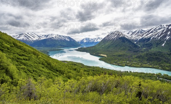 View of snowy mountains in spring and turquoise blue Kenai Lake, Slaughter Ridge Trail, Cooper