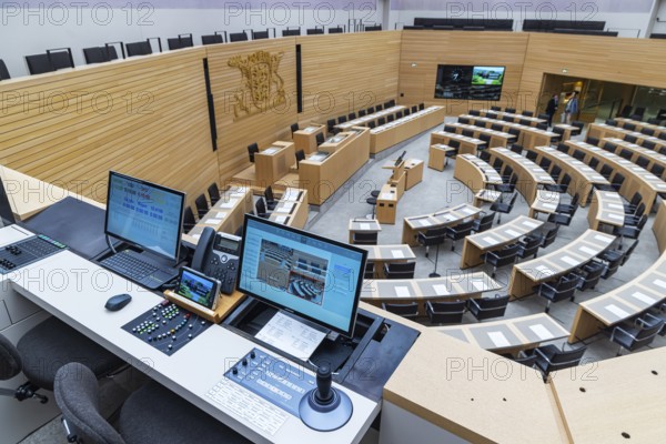 Plenary hall deserted with the seats of deputies and the government bank. Behind it is the
