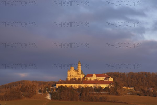 Benedictine monastery with late baroque monastery church, lighting atmosphere, winter, Neresheim,