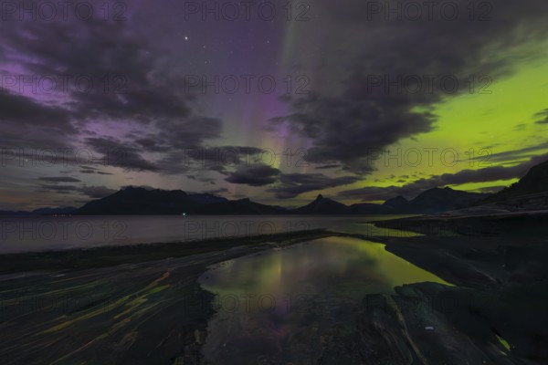 The Vestfjord in Nordland, Norway, has an enchanting atmosphere at night. Dark clouds and vivid