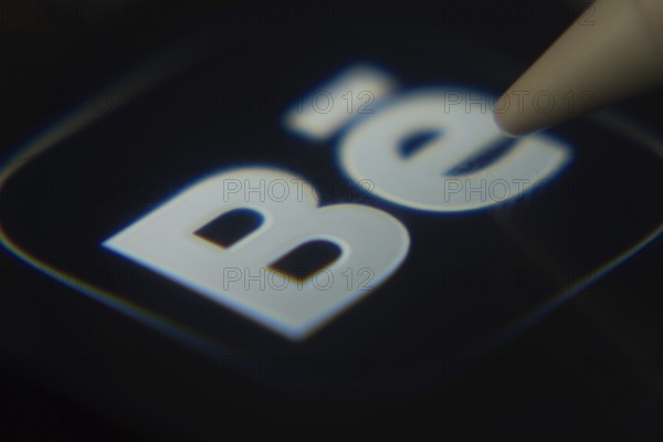 Dhaka, Bangladesh- 06 Dec 2025: Close-up of the Behance app on a screen with a stylus pointing at