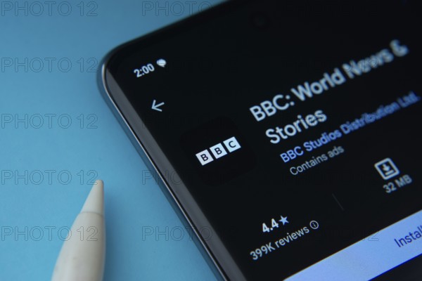 Dhaka, Bangladesh- 29 May 2025: On a blue surface, a smartphone displays the BBC app within the