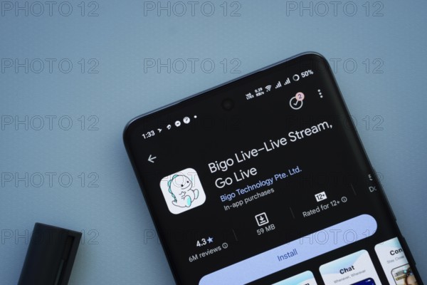 Dhaka, Bangladesh- 29 May 2025: On a blue surface, a smartphone displays the Bigo Live app within