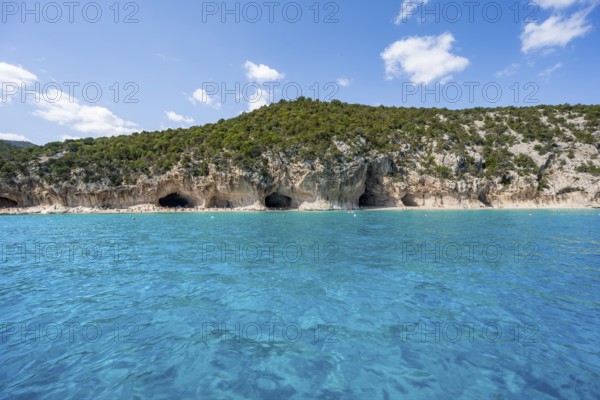 Clear blue water and picturesque rocky coast, Cala Luna cliffs and beach, Golfo di Orosei, Baunei,