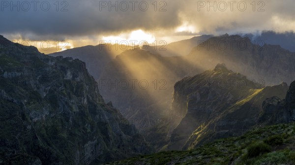Sunset at Pico do Arieiro, sun shining through clouds, sunbeam, hiking trail PR1, Madeira, Portugal