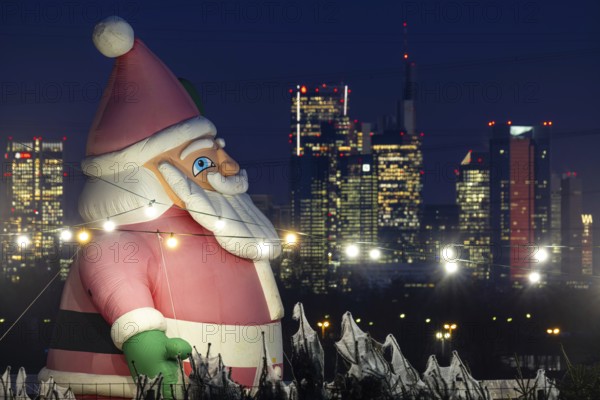 In a Christmas tree center near Frankfurt am Main, a multi-metre-high inflated figure of Santa