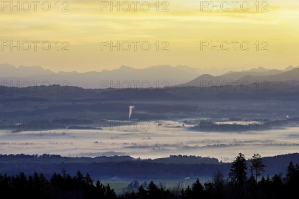 View from Horben of the Reuss Valley covered in fog, behind it the Glarus Alps in the light of the
