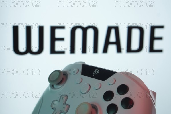 Dhaka, Bangladesh- 14 Nov 2025: A close-up of a gamepad with the WeMade Entertainment seen on