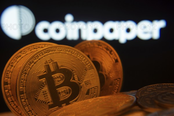 Dhaka, Bangladesh- 19 Sep 2025: Close-up of Bitcoin coins with the Coinpaper logo visible on a