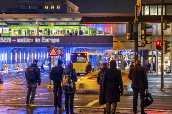 The main train station in Essen, blue illuminated underpass, bus station, am Europaplatz, train on
