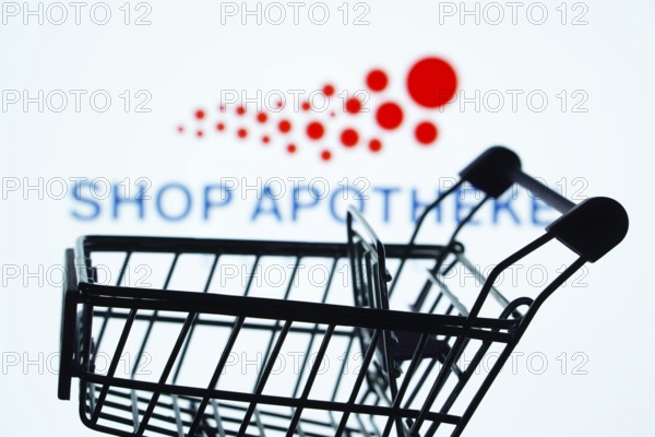 Dhaka, Bangladesh- 21 Nov 2025: Silhouette of a shopping cart in front of the Shop Apotheke logo,