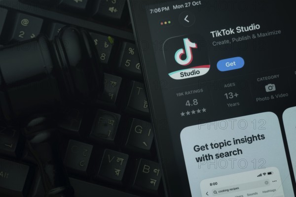 Dhaka, Bangladesh- 28 Oct 2025: An iPad displaying the tiktok Studio app against a judge's gavel
