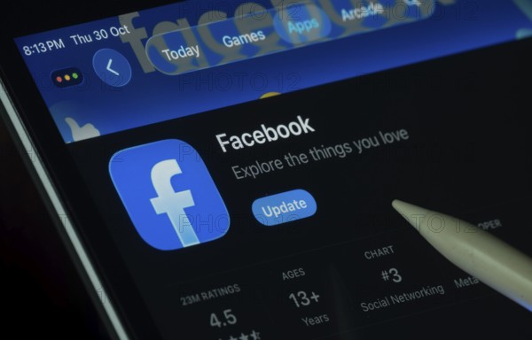 Dhaka, Bangladesh- 30 Oct 2025: Facebook app displayed on a iPad screen in dark mode with a digital