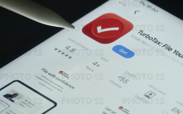 Dhaka, Bangladesh- 30 Oct 2025: TurboTax app on a iPad screen with a pen pointing at the install