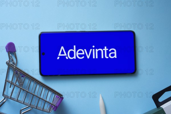 Dhaka, Bangladesh- 03 July 2025: Smartphone displaying Adevinta logo with shopping cart on a blue