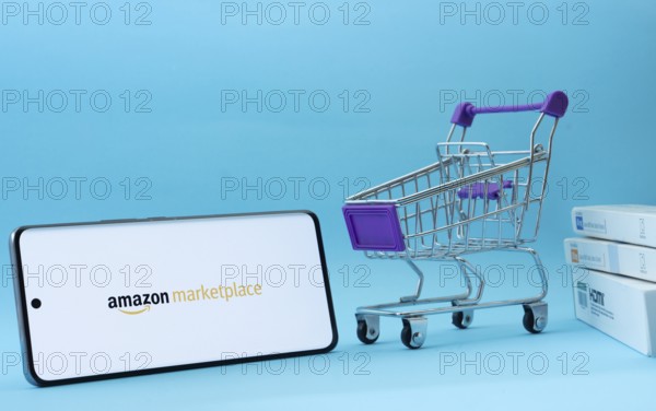 Dhaka, Bangladesh- 21 Nov 2025: Smartphone with amazon marketplace logo next to a small shopping
